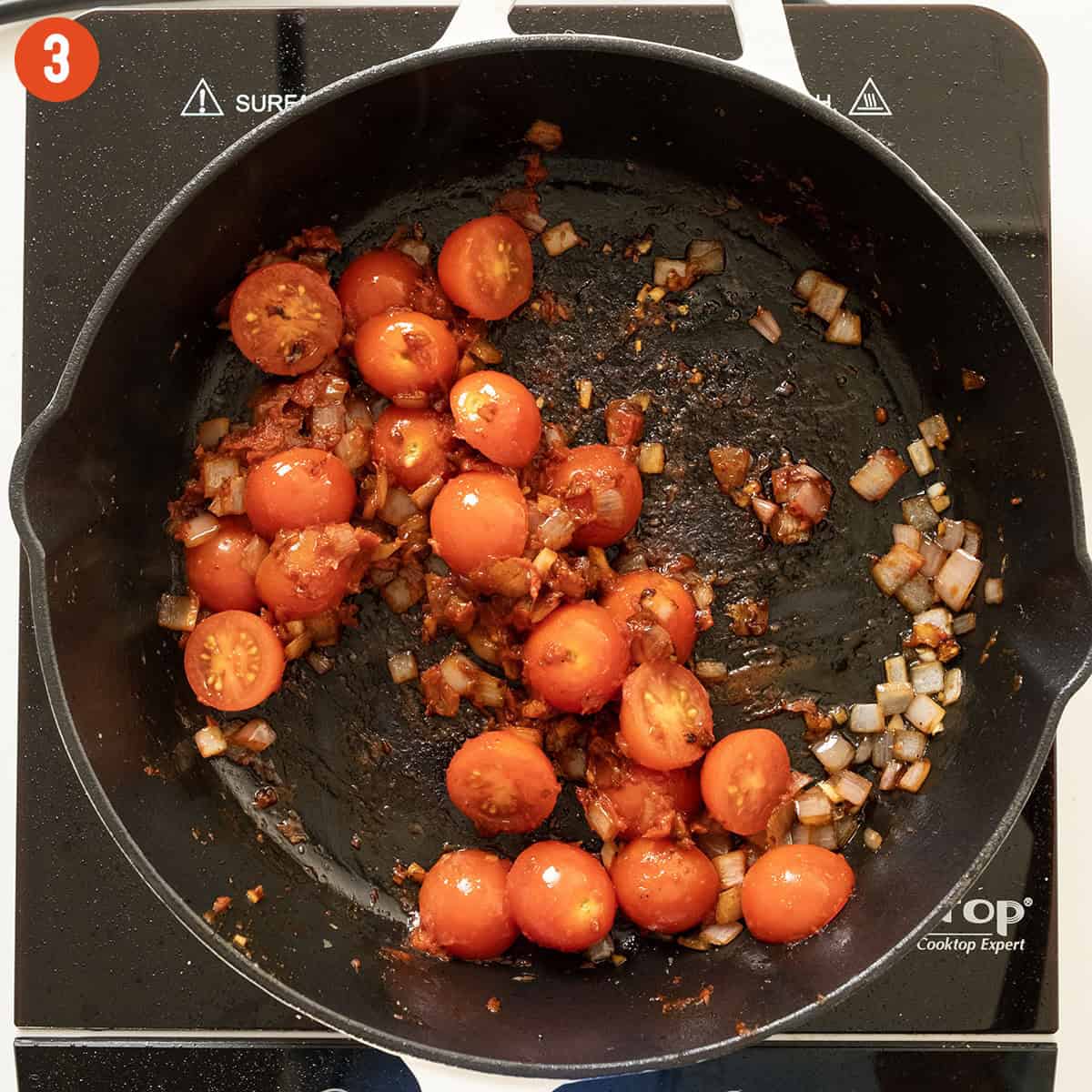 Sauteing cherry tomatoes in saucepan.