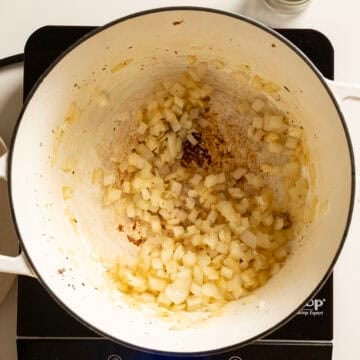 Sauteing onions in a pot.