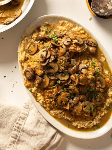 Veal marsala topped with mushrooms over risotto.