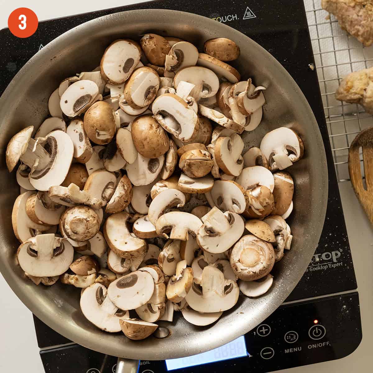 Sauteing mushrooms in a pan.