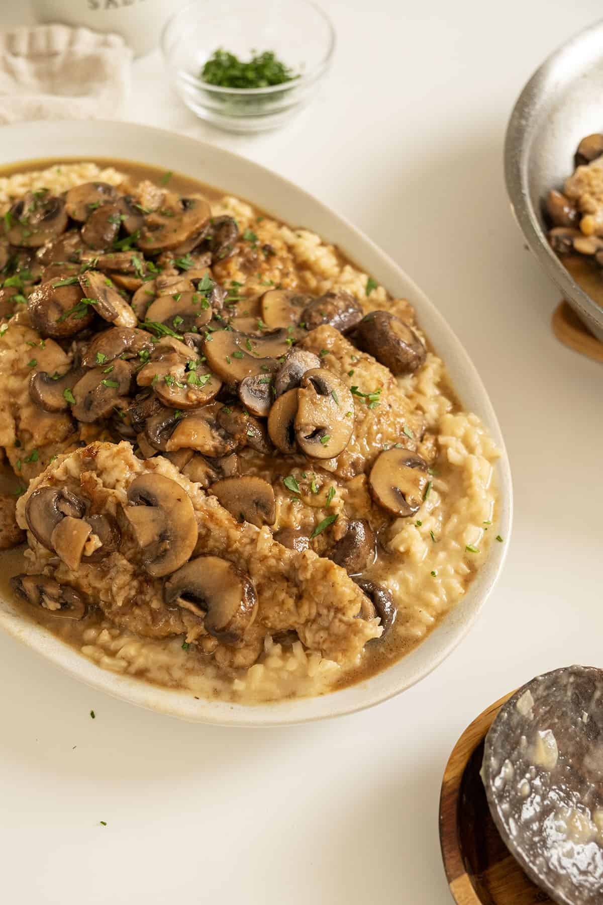 Veal marsala topped with mushrooms over risotto.