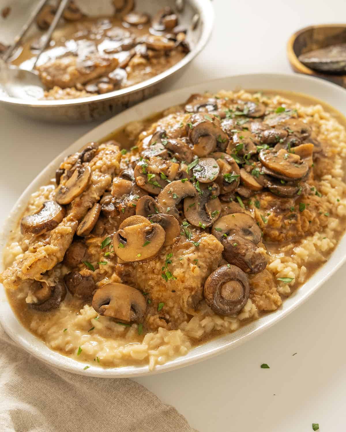 Veal marsala topped with mushrooms over risotto.