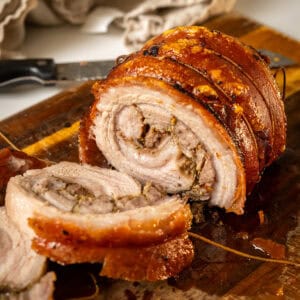 Rolling and tying porchetta from the outside in.