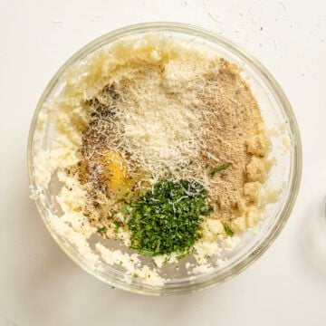 Egg, breadcrumbs, parmesan, parsley, salt, and pepper combined with mashed cauliflower.