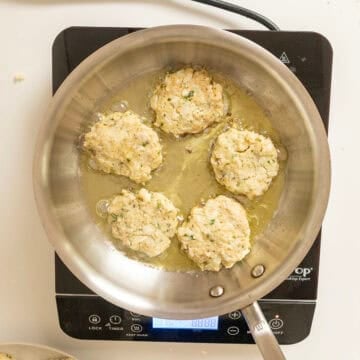 Frying cauliflower cakes in olive oil.