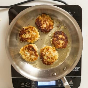 Golden brown cauliflower cakes fried in olive oil.