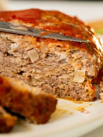 Italian meatloaf sliced on a plate.