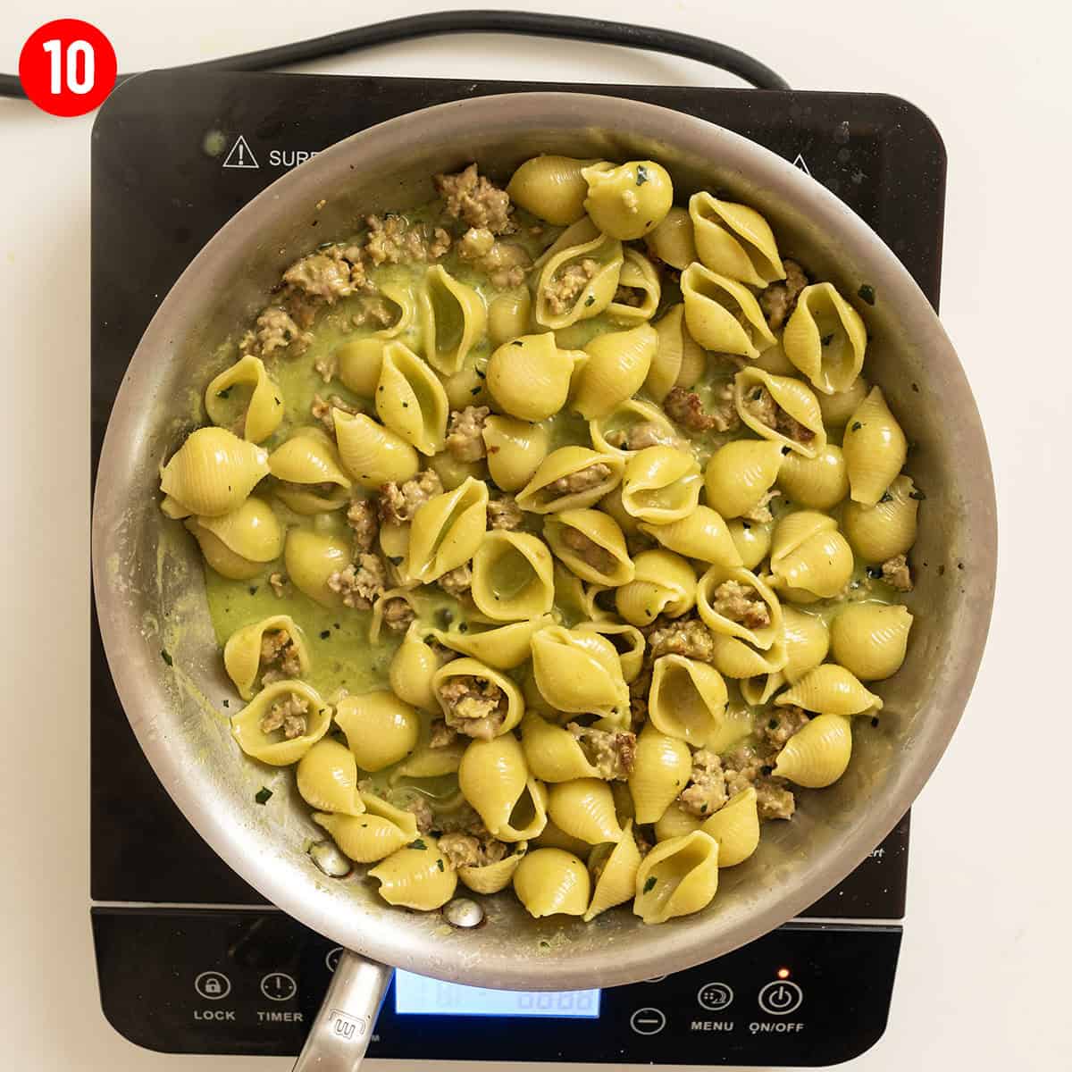 Kale and walnut pesto with shell pasta in a bowl.