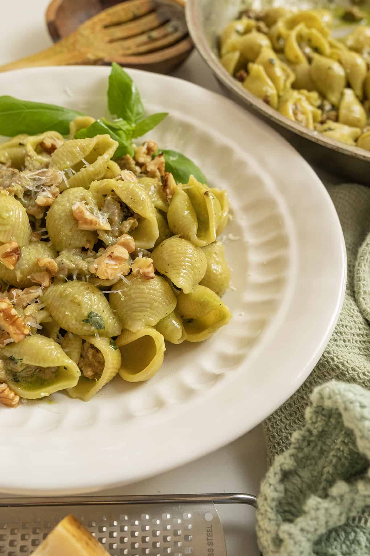 Kale and walnut pesto with shell pasta in a bowl.