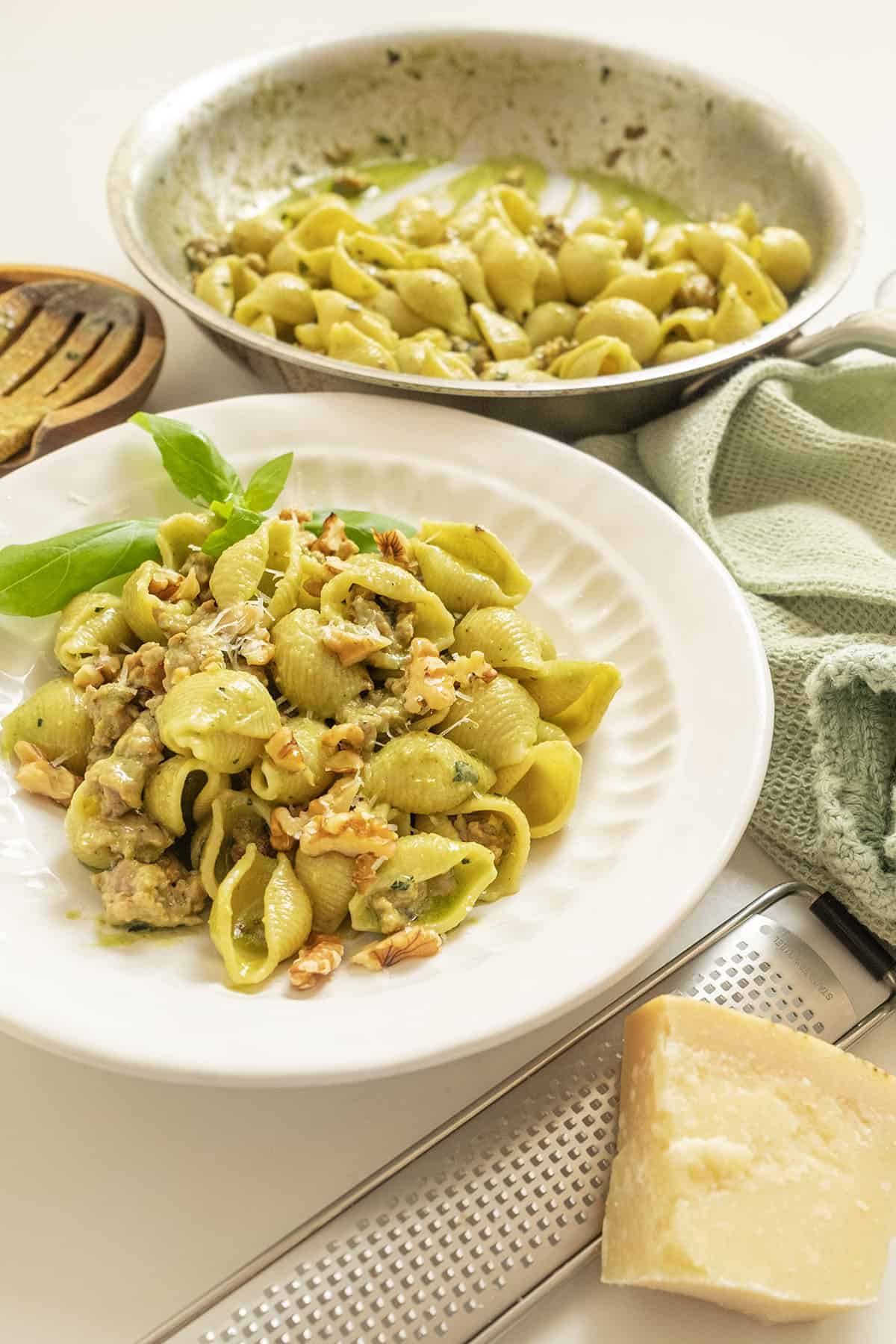 Kale and walnut pesto with shell pasta in a bowl.