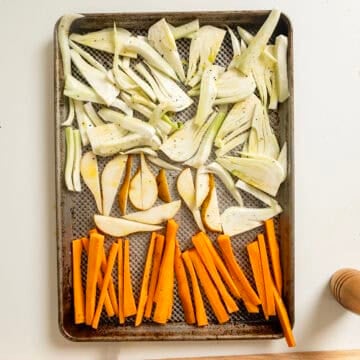 Fennel, carrots, and pears on a baking pan.