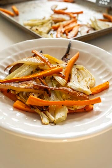 Pear, carrots, and fennel in a bowl.