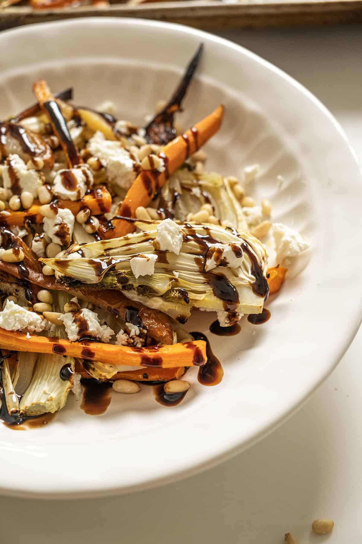 Roasted Carrots and fennel topped with pine nuts and balsamic glaze.