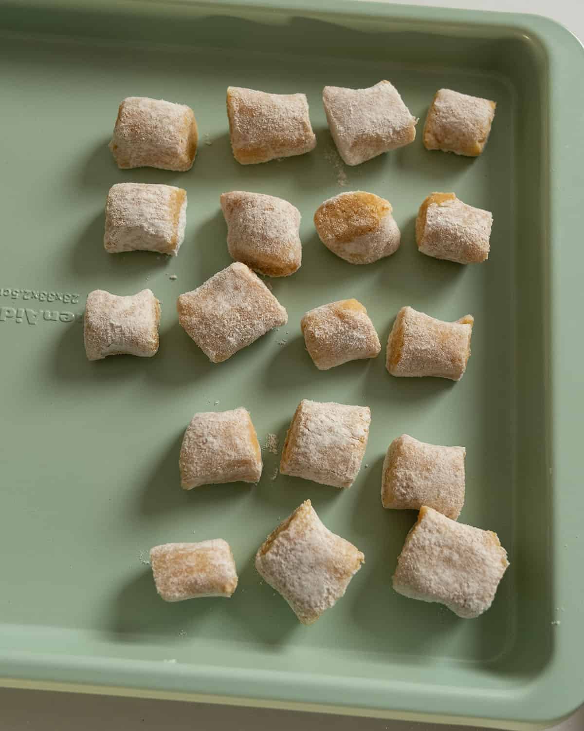 Gnocchi separated out on a baking tray.