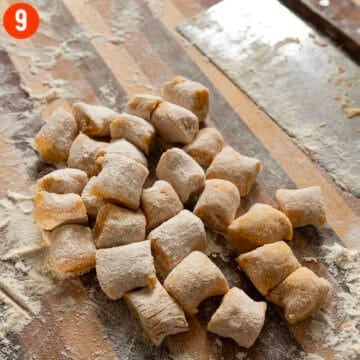 Homemade pumpkin gnocchi on a cutting board.