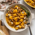 Gnocchi with pumpkin sauce and sausage.