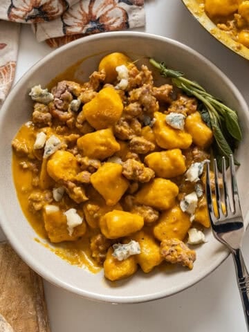 Gnocchi with pumpkin sauce and sausage.