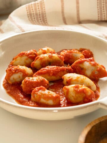 Stuffed calamari in tomato sauce on a plate.