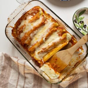 Baked manicotti topped with smooth marinara and mozzarella.
