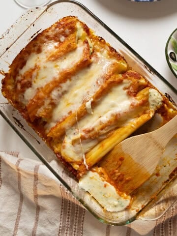 Baked manicotti topped with smooth marinara and mozzarella.