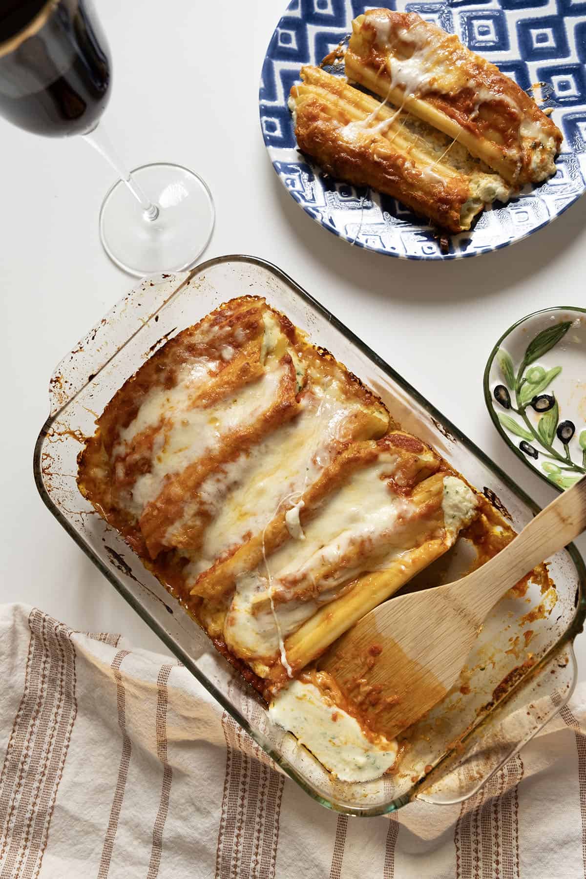 Baked manicotti topped with smooth marinara and mozzarella.