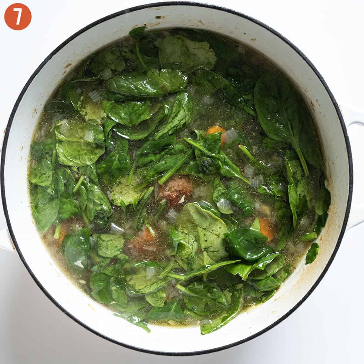 Wilting spinach in soup.