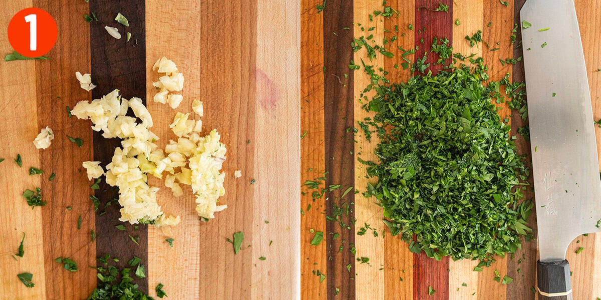 Chopped garlic and parsley on a cutting board.