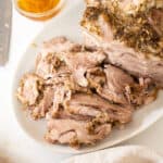 Sliced pork shoulder on a cutting board.