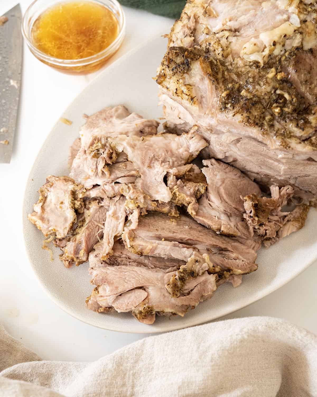 Sliced pork shoulder on a cutting board. 