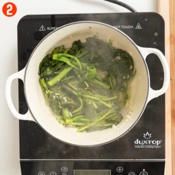 Sauteing broccoli rabe in dutch oven with garlic.