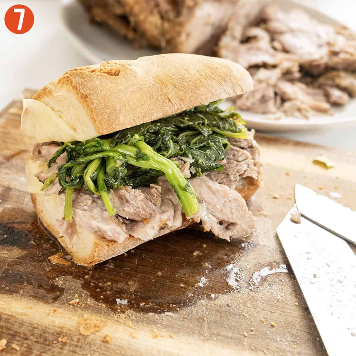 Serving Italian Pork sandwich on a cutting board.
