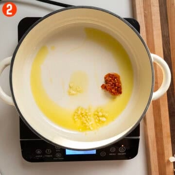 Saute garlic and calabrian chili peppers.