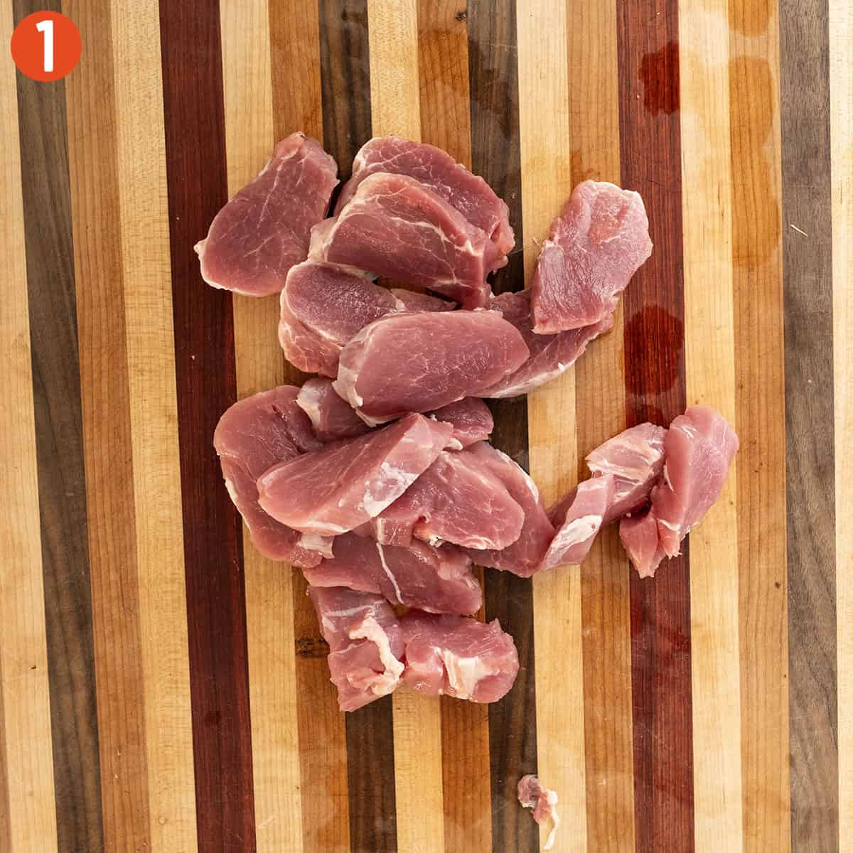 Slicing pork tenderloin into ½ inch slices.