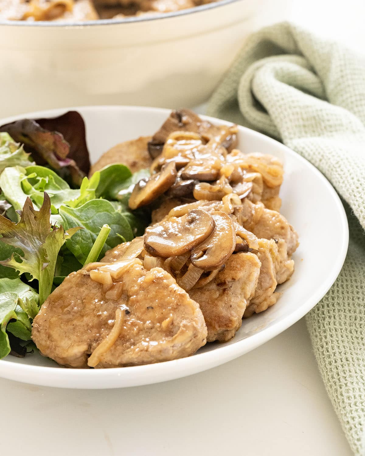 Pork tenderloin medallions in marsala sauce in a braiser.