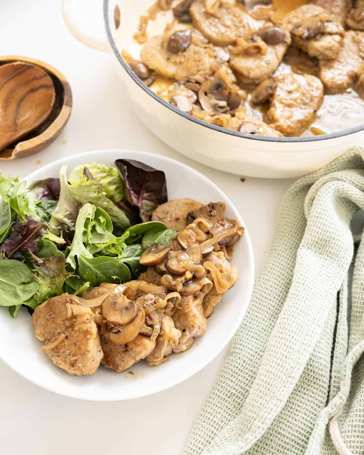 Pork tenderloin medallions in marsala sauce in a braiser.