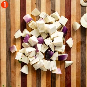 Cutting eggplant into 1 inch pieces.