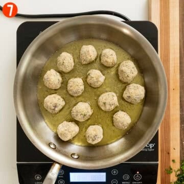 Frying eggplant meatballs in a sauce pan.