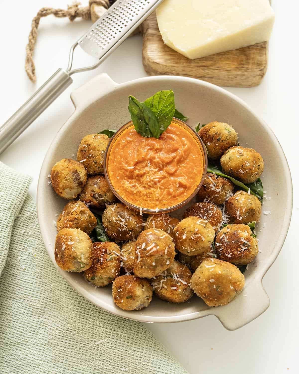 Polpette di Melanzane or eggplant meatballs in a bowl with sauce.
