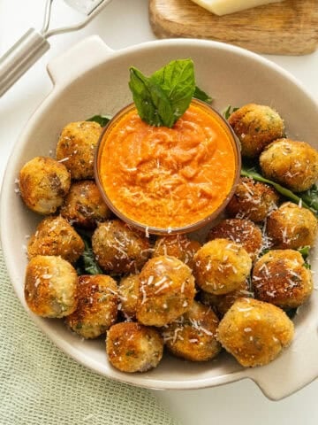 Polpette di Melanzane or eggplant meatballs in a bowl with sauce.