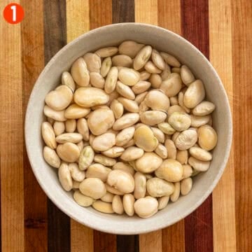 Soaking broad beans in a bowl.