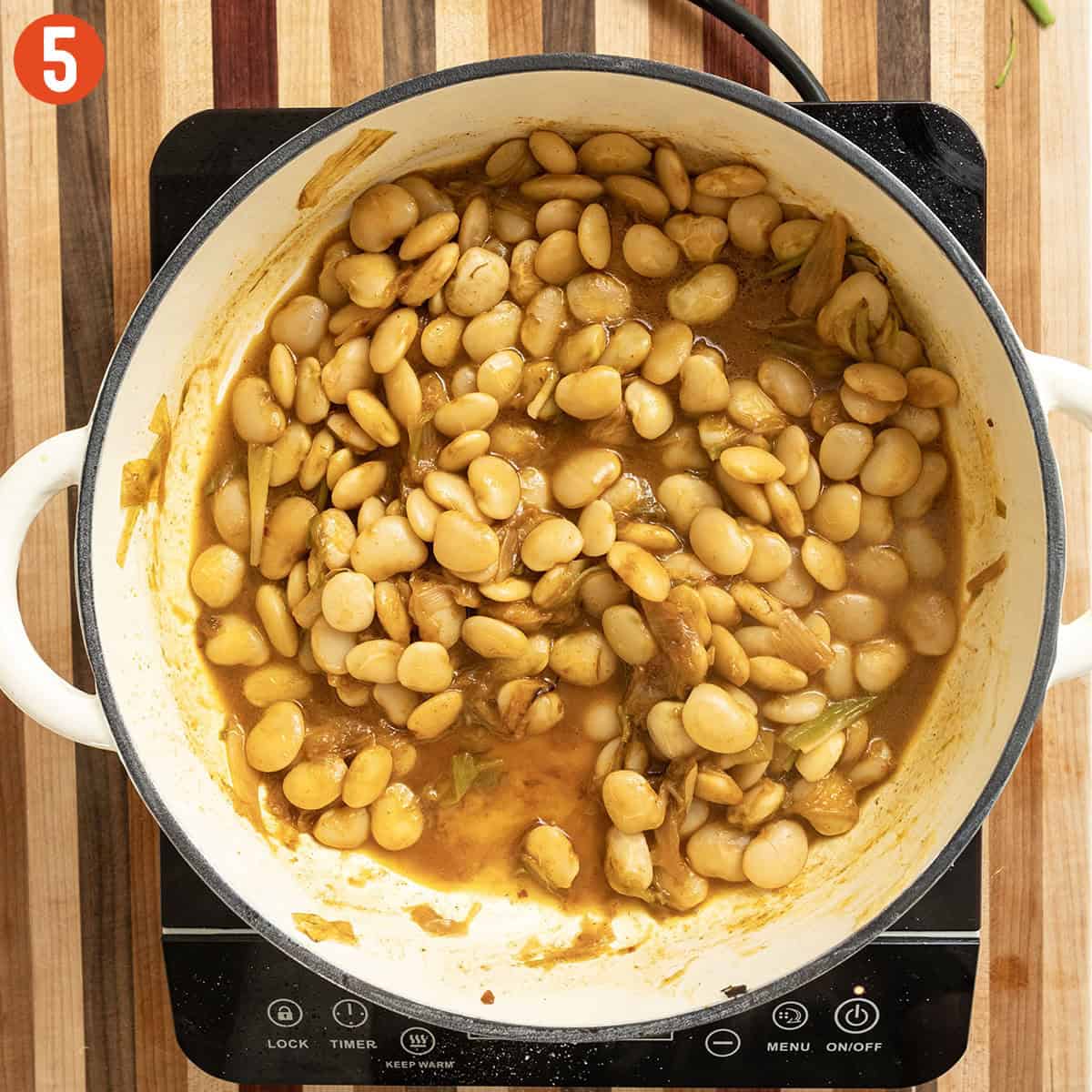 Stewed broad beans in a pot.