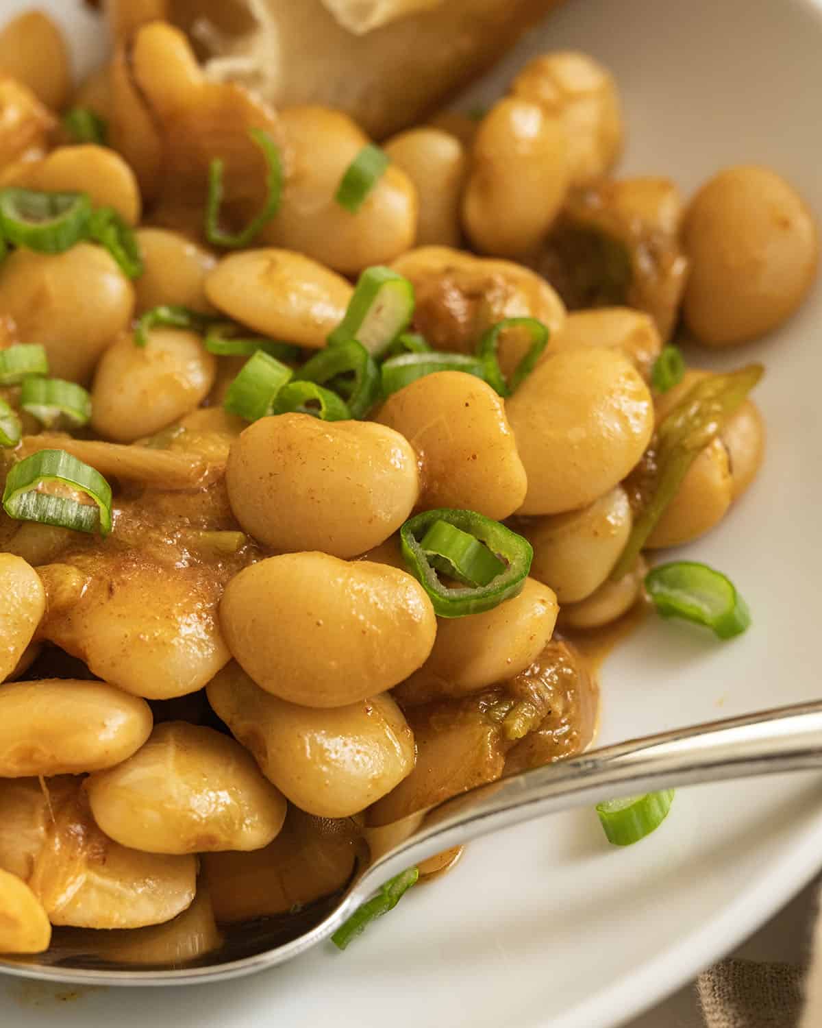 Broad beans topped with green onions.