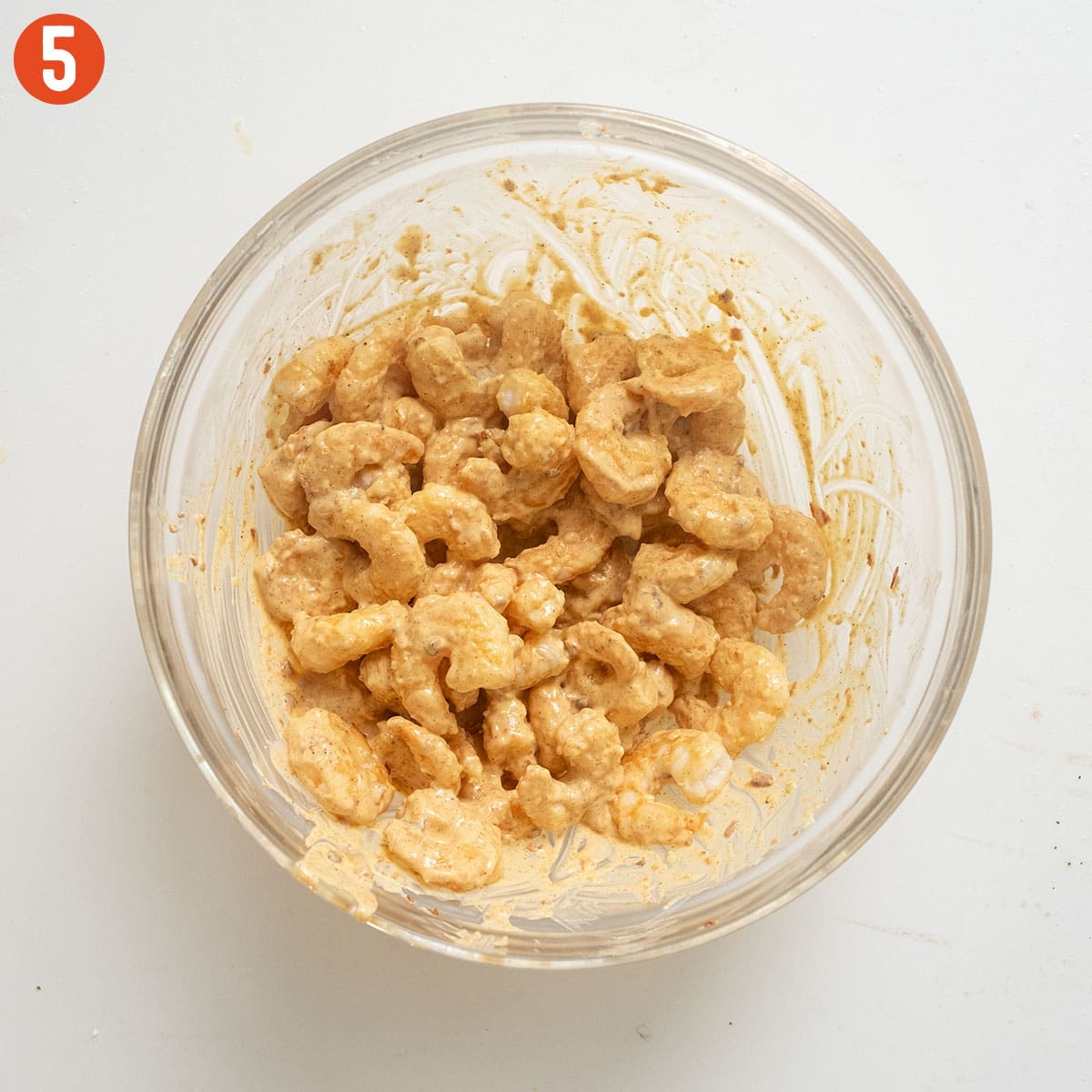 Fried shrimp combined with volcano sauce in a bowl.