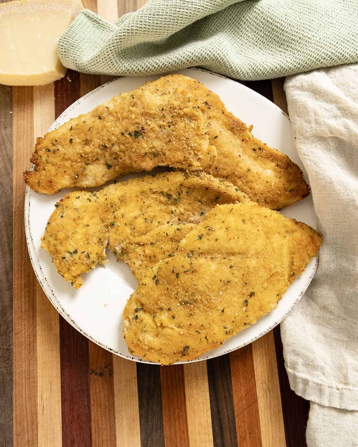 Oven baked chicken cutlets on a plate.