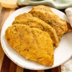 Oven baked chicken cutlets on a plate.