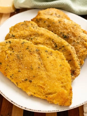 Oven baked chicken cutlets on a plate.