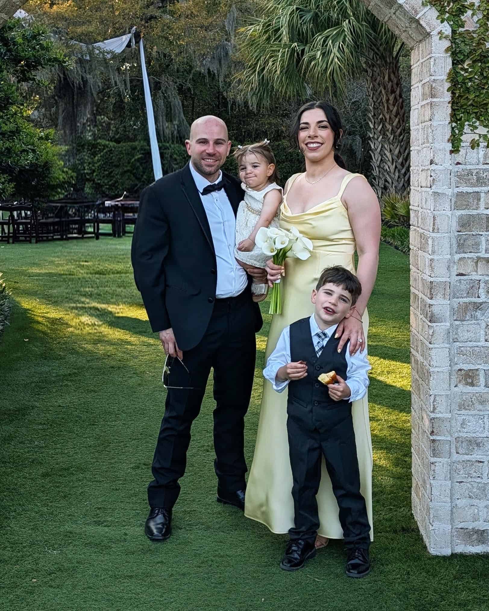 The DelGiudice family below an arch, including, Vinny, Marisa, and their children.