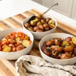 Foil potatoes 3 ways on a cutting board.