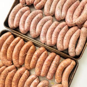 Homemade sausage on baking trays.