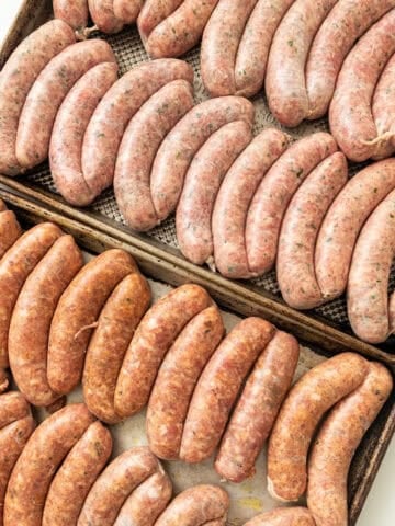 Homemade sausage on baking trays.
